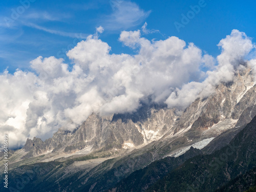 Dense cumulus clouds covered the peaks of the Alps. The slopes of the mountains are steep, impassable.