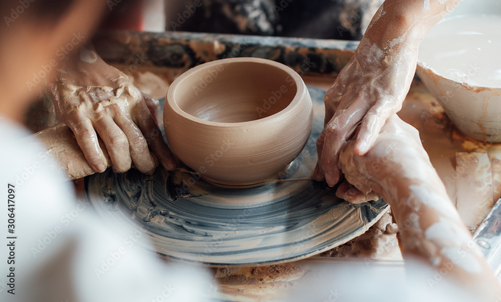 Close up the woman's hands following teacher to cut pottery at Ceramic clay workshop. Handcraft Ceramic Work.