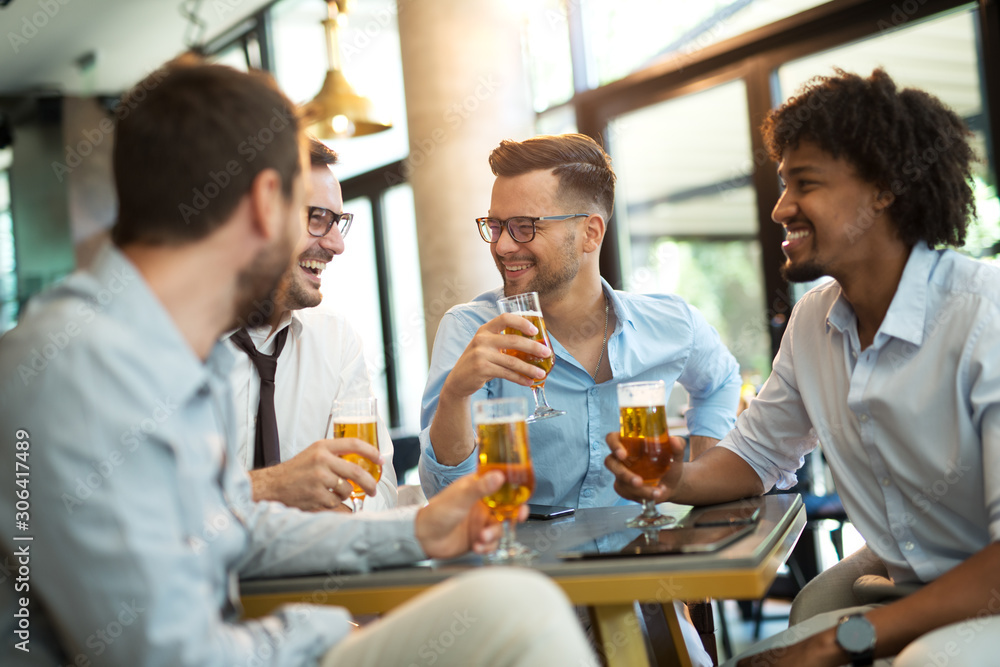 Funny conversation four businessmen while sit pub and drinking beer after work Funny conversation four businessmen while sit pub and drinking beer after work