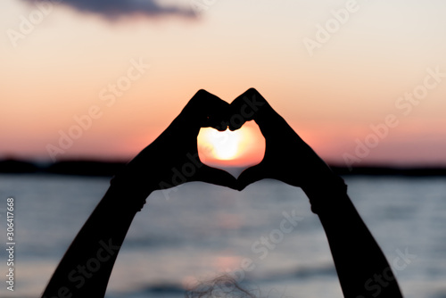 Heart with hands at dawn