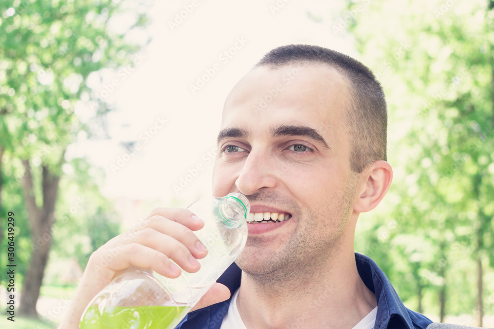 Traveler drinking from a bottle of drink, portrait, close up, toned Traveler drinking from a bottle of drink, portrait, close up, toned