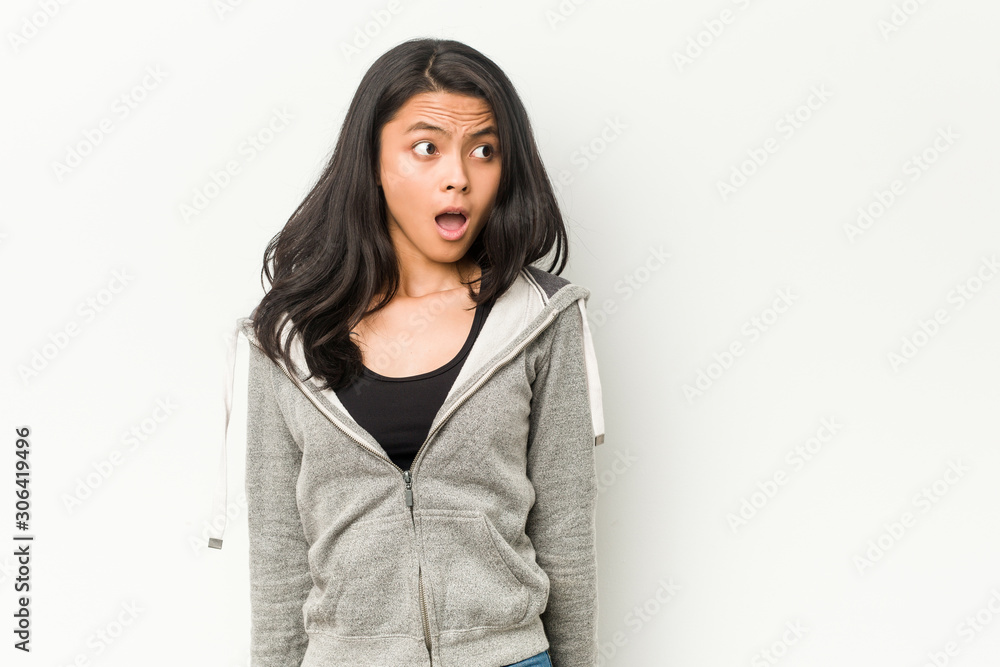 Young fitness chinese woman being shocked because of something she has seen. Young fitness chinese woman being shocked because of something she has seen.