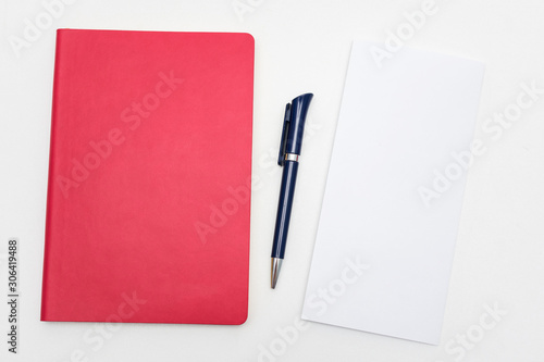 Office worker's Desk, pen and red notebook, letter or white piece of paper, copy space, close up, top view © Анастасия Семашко