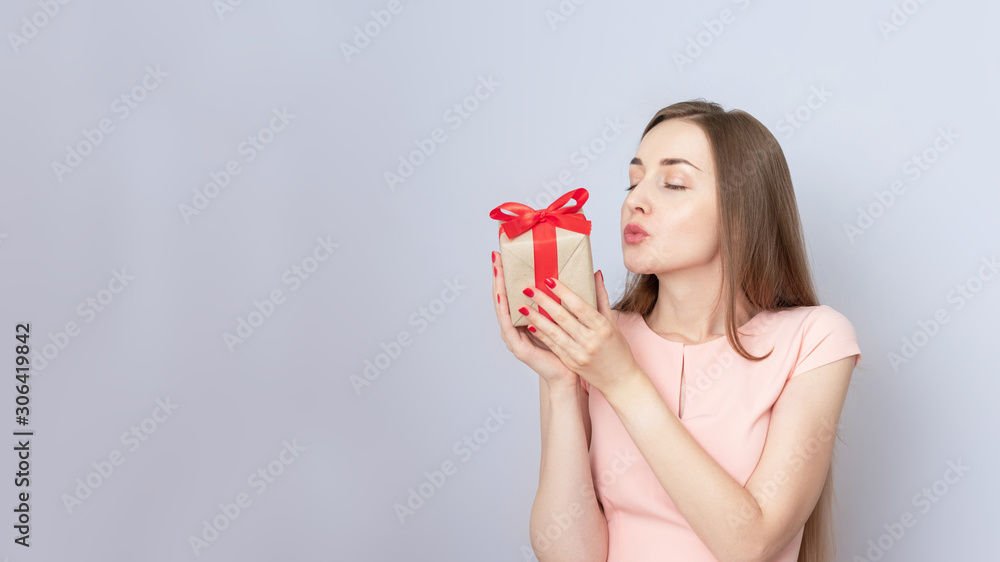 Happy young woman received a gift, woman sends air kiss, portrait, copy space, toned Happy young woman received a gift, woman sends air kiss, portrait, copy space, toned