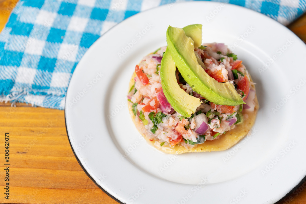 Mexican fish ceviche with avocado on wooden background Mexican fish ceviche with avocado on wooden background