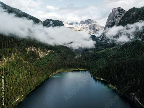 Panoramic view of Gosausee  lake with Dachstein glacier background. Magical landscape  scene of Austrian Alps  Austria  Europe. Captured from above wuth drone.