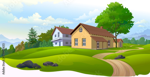 Houses in Europe with green meadows, dirt road and a vast landscape of mountains 