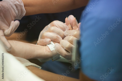 Doctor holding patient's hand at hospital