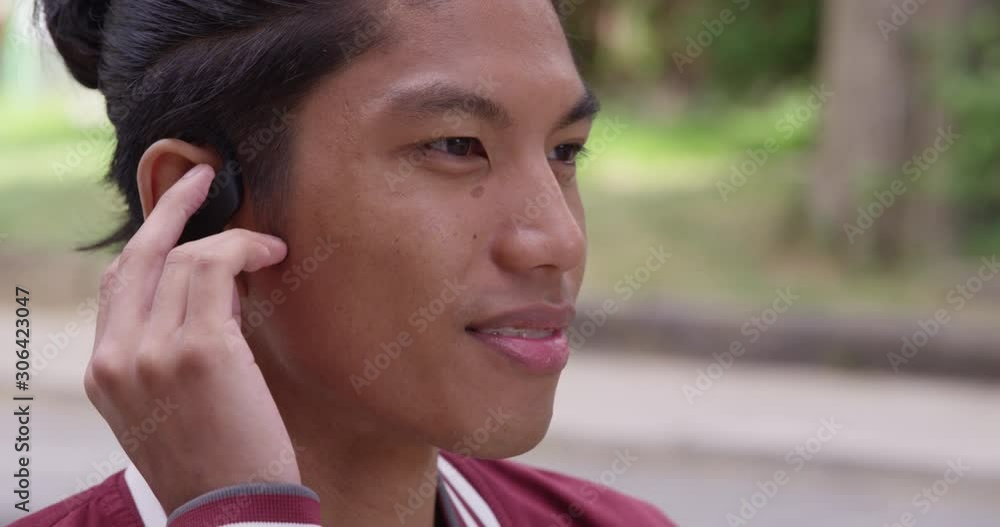 Young attractive man with headphones dances to the music playing, eyes closed. - shot on RED Young attractive man with headphones dances to the music playing, eyes closed. - shot on RED