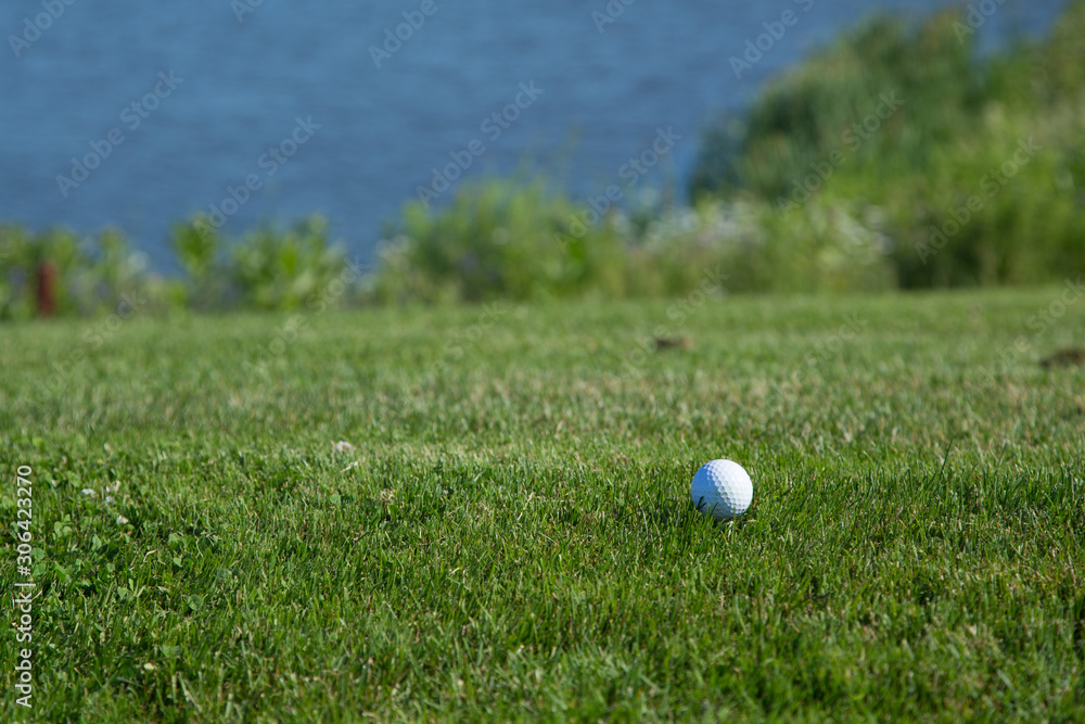 Beautiful green golf course with a golf ball in focus copy space mock up Beautiful green golf course with a golf ball in focus copy space mock up