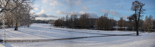 Snowy sunset park view at a pond on the Drottningholm island 
