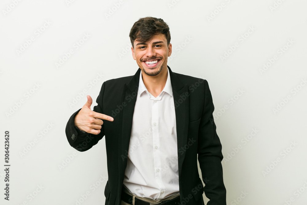 Young business hispanic man person pointing by hand to a shirt copy space, proud and confident Young business hispanic man person pointing by hand to a shirt copy space, proud and confident