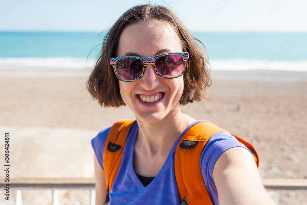 A girl takes a selfie on the beach. A girl takes a selfie on the beach.