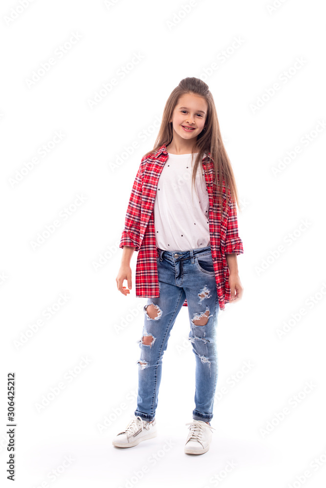 Studio shot of a young smiling girl wearing jeans and a red checked shirt , isolated Studio shot of a young smiling girl wearing jeans and a red checked shirt , isolated