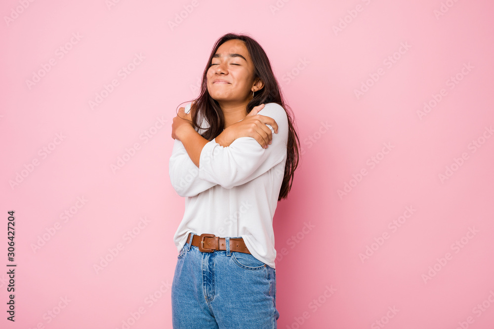 Young mixed race indian woman hugs, smiling carefree and happy. Young mixed race indian woman hugs, smiling carefree and happy.
