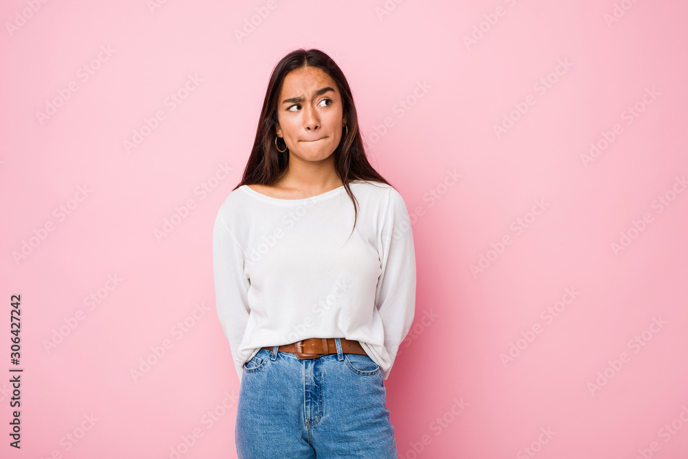 Young mixed race indian woman confused, feels doubtful and unsure. Young mixed race indian woman confused, feels doubtful and unsure.