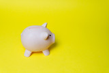 pink piggy bank isolated on yellow background, top view