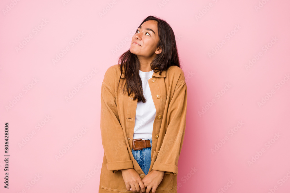 Obraz premium Young mixed race indian woman isolated dreaming of achieving goals and purposes
