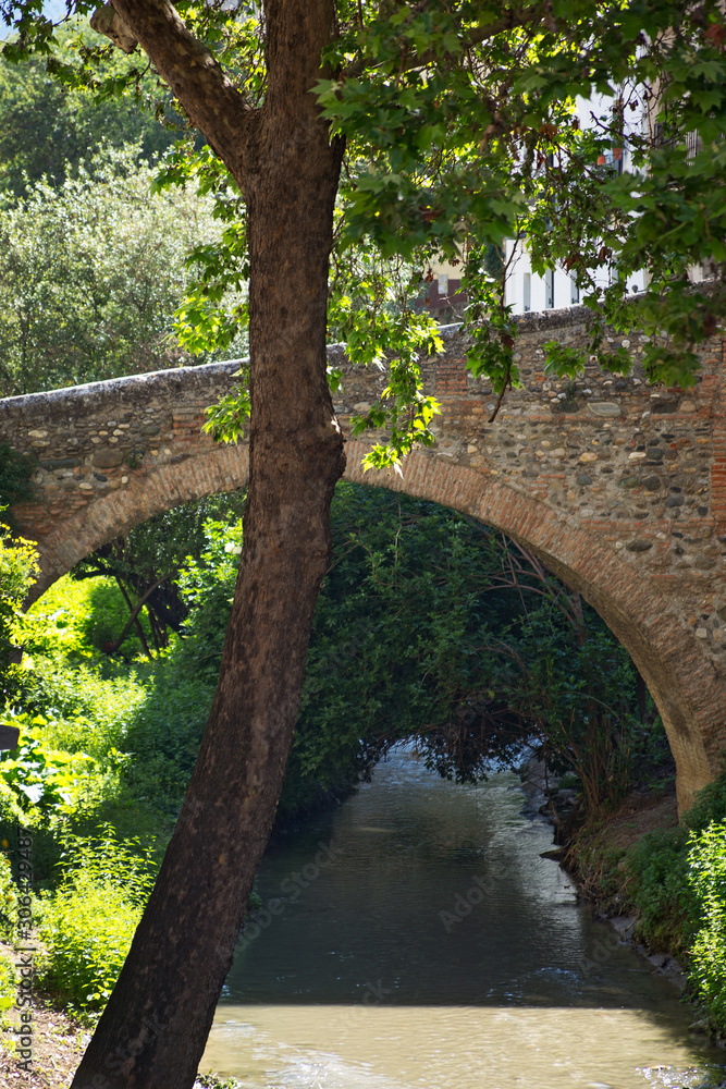 The Darro river and a medieval bridge in Albaicin district of Granada, Spain The Darro river and a medieval bridge in Albaicin district of Granada, Spain