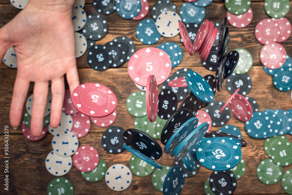 Poker chips in female hands abstract background.
