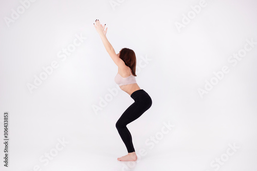 Young beautiful girl performs yoga exercises