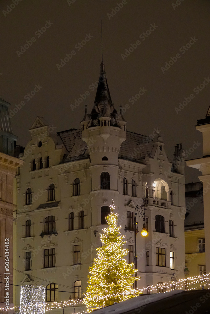 VERTICAL Christmas lights and ornaments light up historic buildings in
