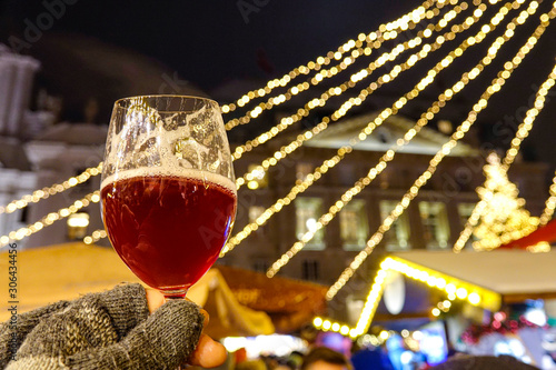 Photography CLOSE UP Person wearing woollen gloves holds up a glass of delicious mulled wine