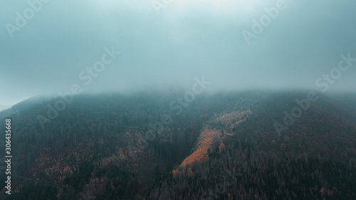 Fog and clouds in the valley of a mountain lake. Flying over a mountain nature landscape with view from above. Harz Mountains photo