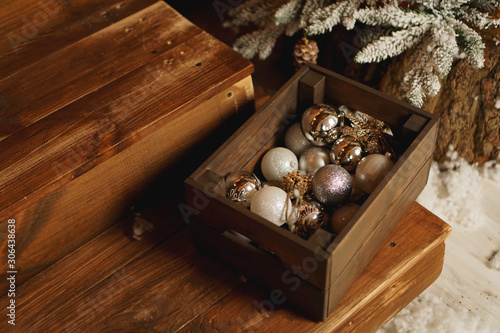 Christmas decorations in a box on a wooden table. Wooden box filled with christmas decorations. Xmas.
