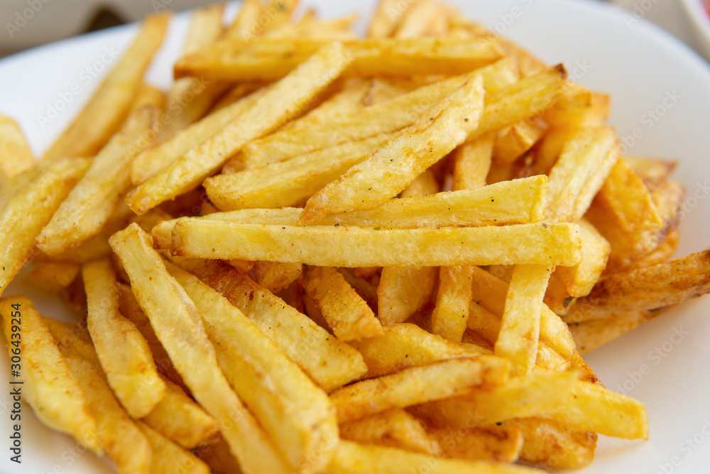 at home, french fries. close-up of finely chopped fried potatoes on white plate at home, french fries. close-up of finely chopped fried potatoes on white plate