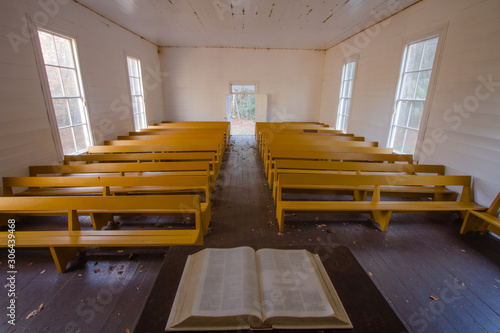 A view of a country church from the pulpit with an open bible.