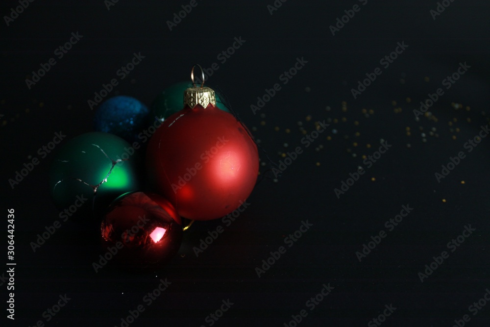Christmas background. Christmas tree toys on a black background with sparkles. Christmas background. Christmas tree toys on a black background with sparkles.