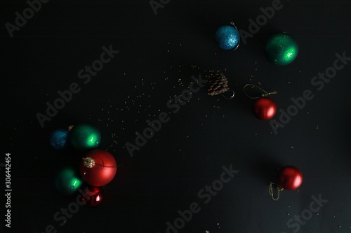 Christmas background. Christmas tree toys on a black background with sparkles.