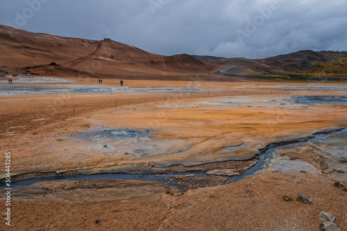 Hverir geothermal area in North Iceland. dy geysers and sulfur field. Orange mountains Iceland.