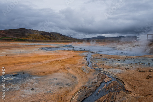 Hverir geothermal area in North Iceland. dy geysers and sulfur field. Orange mountains Iceland.