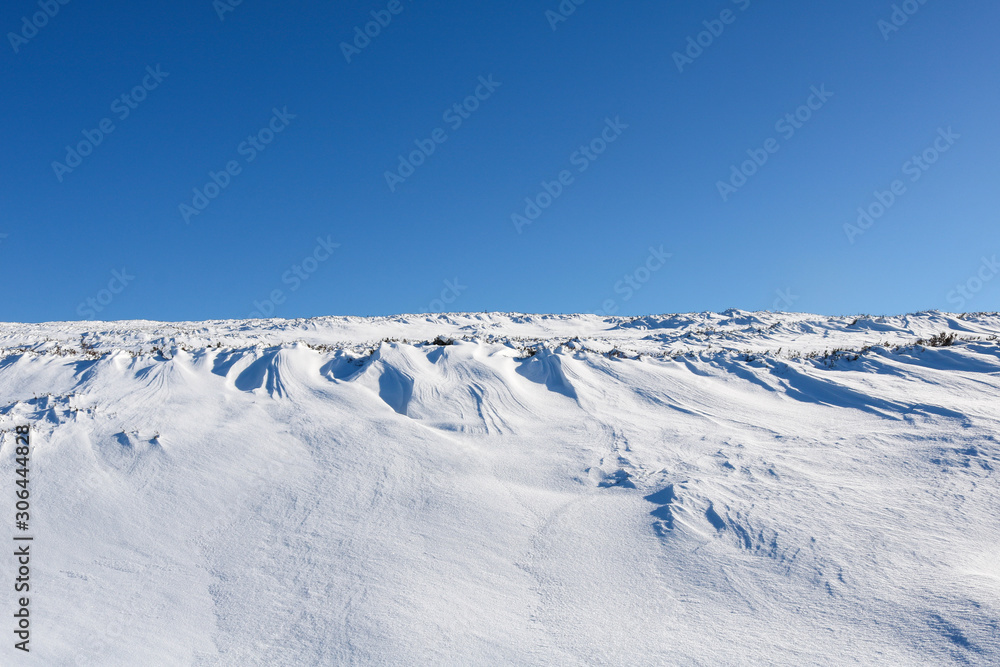 Winter mountain landscape with mountains and blue sky