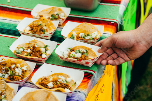 person grabbing taco