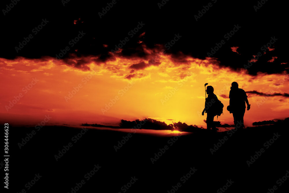 People are walking during SunSet with Selfie stick and mobile phone