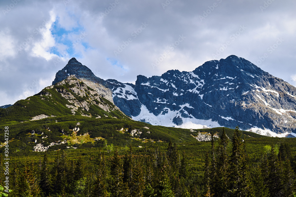 Fototapeta premium Rocky peaks and clouded sky in the Tatra Mountains in Poland..