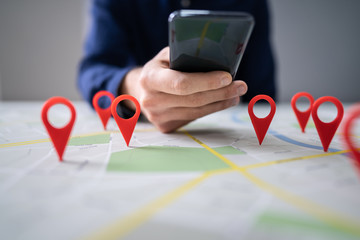 Map With Red Location Marker And Mobile Phone