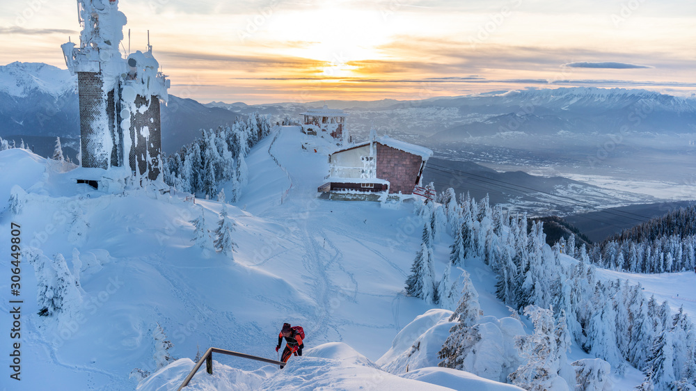 Poiana Brasov, Romania. Postavarul Peak.  The hearth of Transylvania, one of the most picturesque Europe`s ski resort.  Wooden chalets and spectacular ski slopes in the Carpathians.