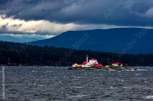 lighthouse at the stormy  gulf Waves Breaking and Spraying at the Seas and Strong Winds  Entrance Island lighthouse off the east coast of Vancouver Island in Georgia Strait. Gabriola Island is located © Alex Lyubar