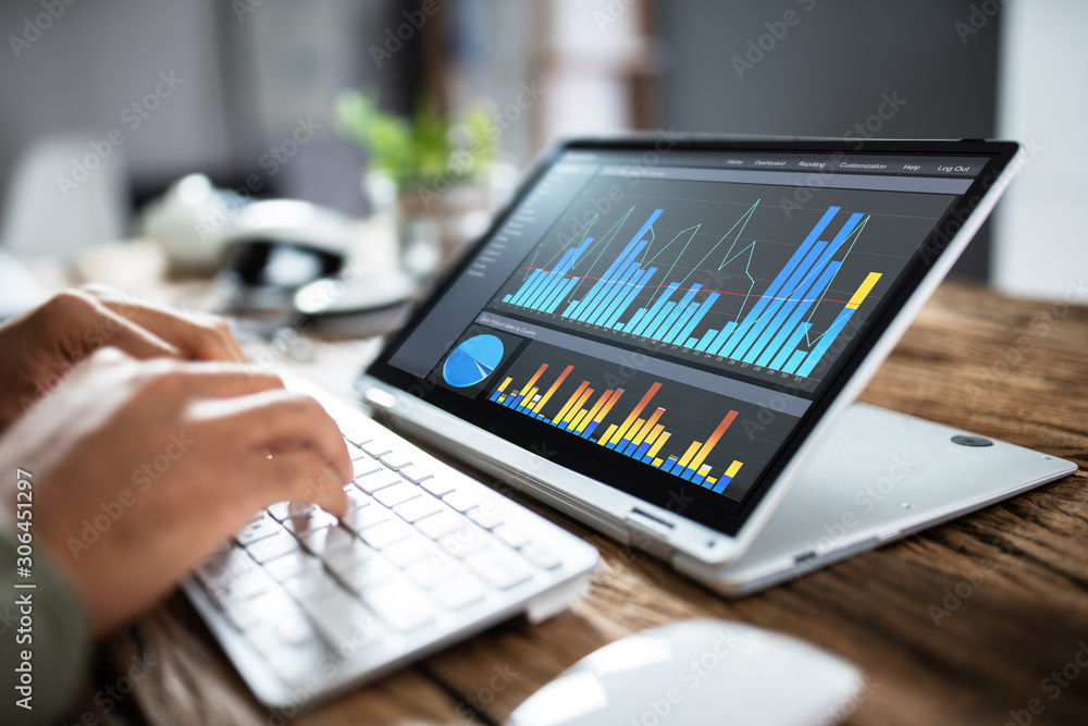 Businessperson Pointing At Graph On Digital Laptop Businessperson Pointing At Graph On Digital Laptop