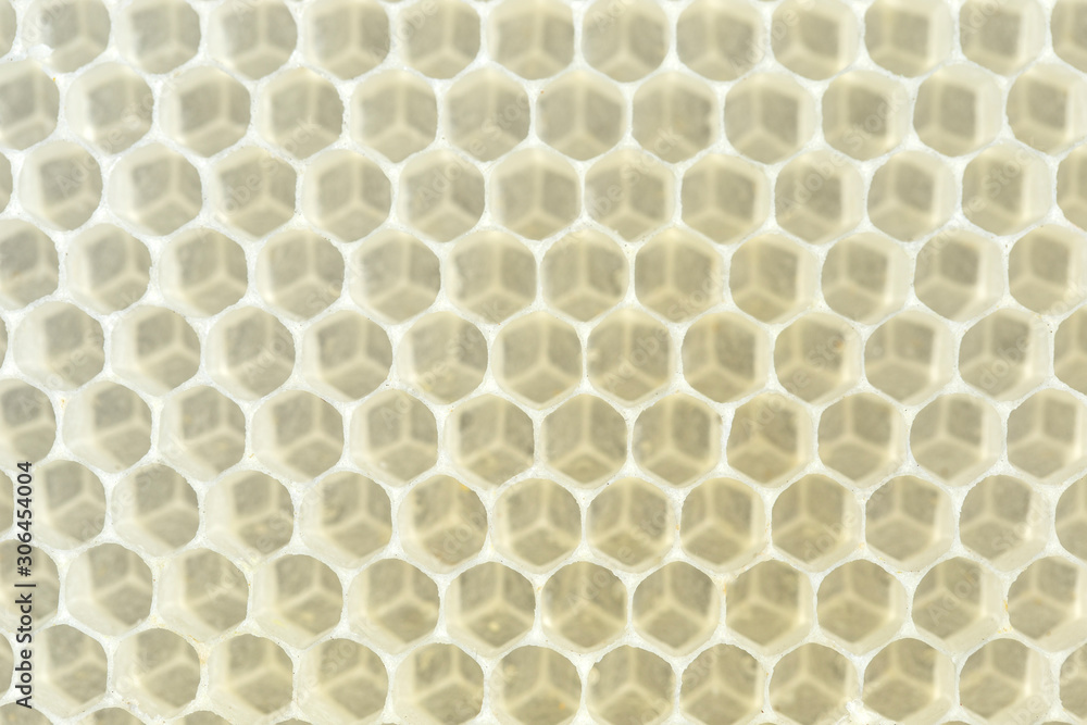 Yellow beeswax clear hexagon background. Natural honeycomb background. Close-up.
