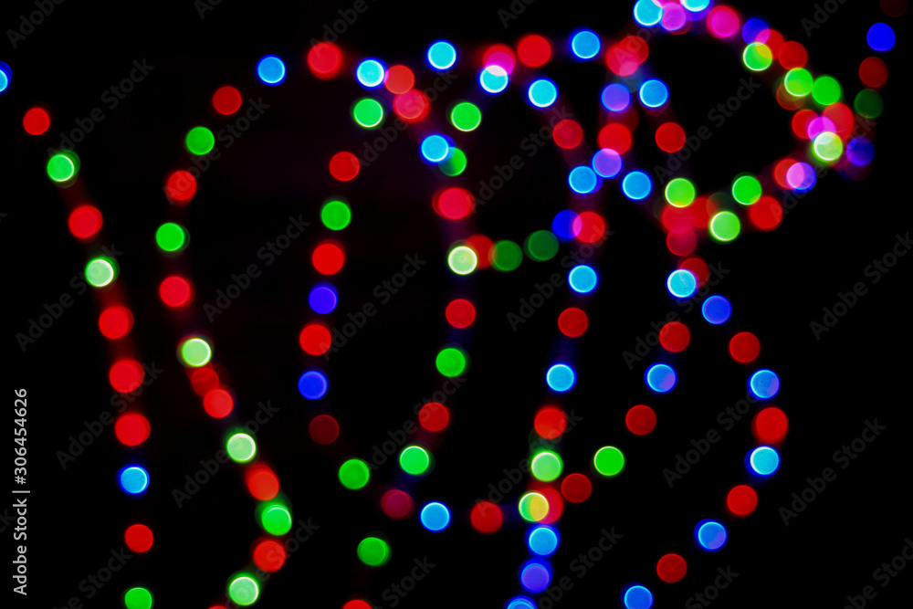 Bokeh effect on round red, green and blue lights. Abstract blurred leds garland for background. Bokeh effect on round red, green and blue lights. Abstract blurred leds garland for background.