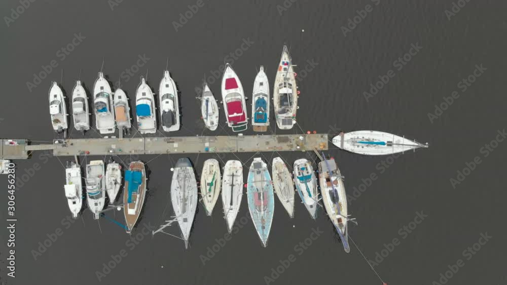 Aerial view on a yaght and boats parking in a calm bay Aerial view on a yaght and boats parking in a calm bay