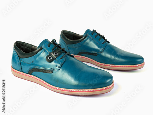Pair of male cyan leather shoes on white background, isolated product, top view.