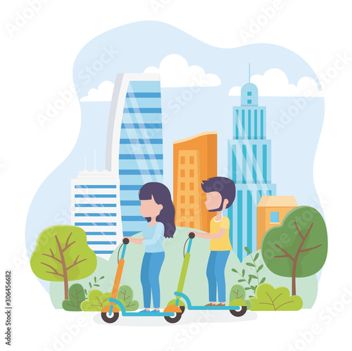 urban ecology young man and woman riding kick scooters in the park town