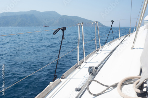Boat trip on a yacht, a fragment of the deck and the mountains on the horizon © Ulia Koltyrina