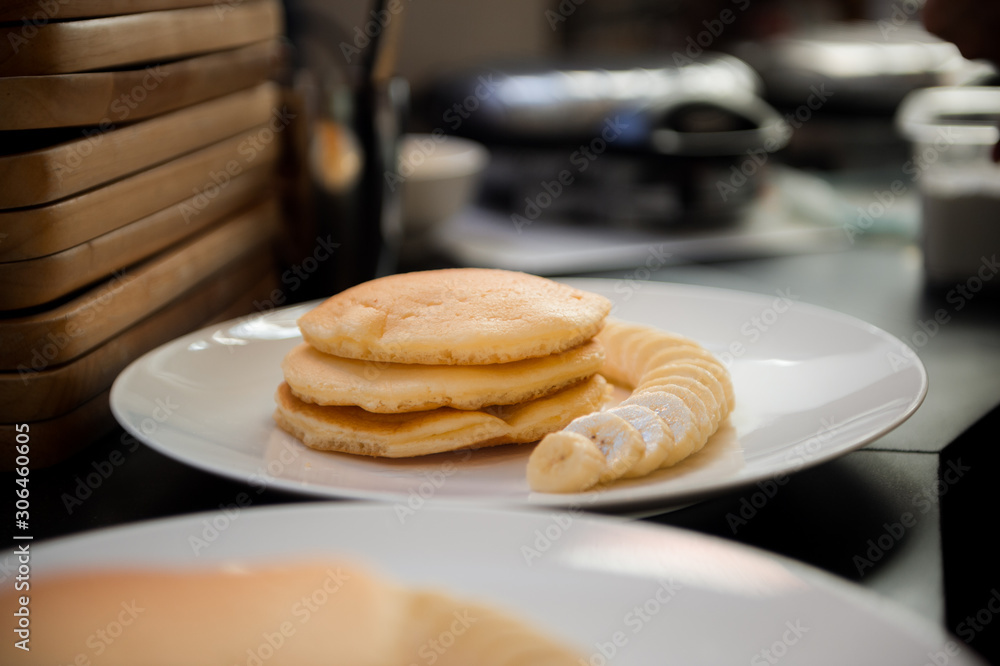 pancakes with banana on white dish pancakes with banana on white dish